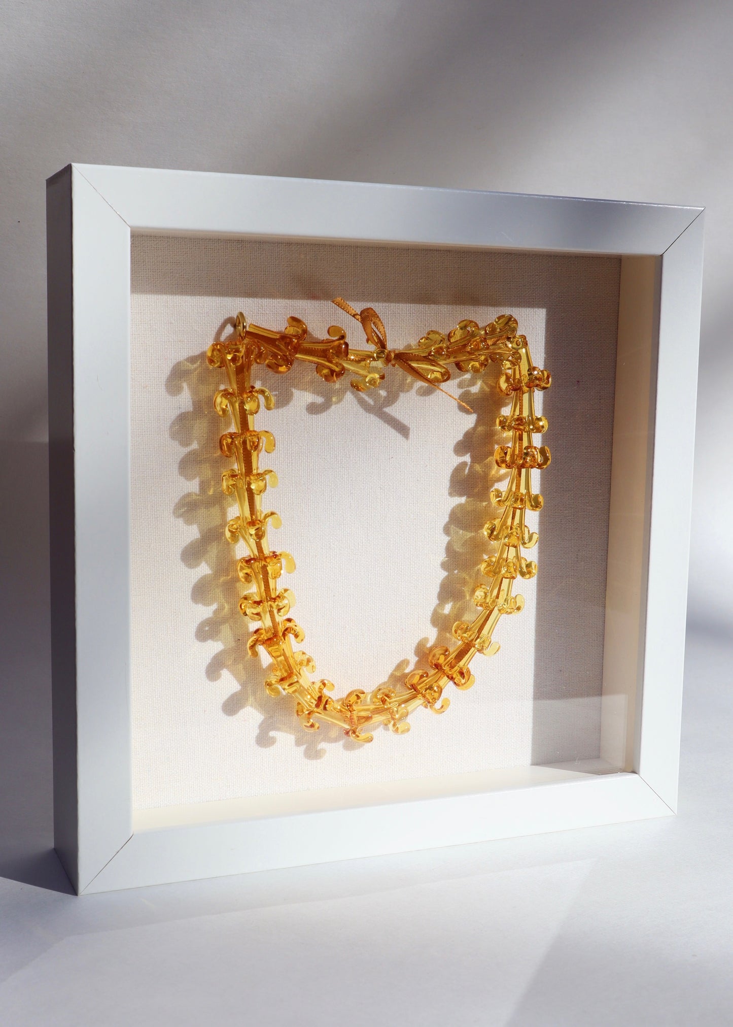 Puakenikeni Glass Lei in 9" x 9" Shadowbox