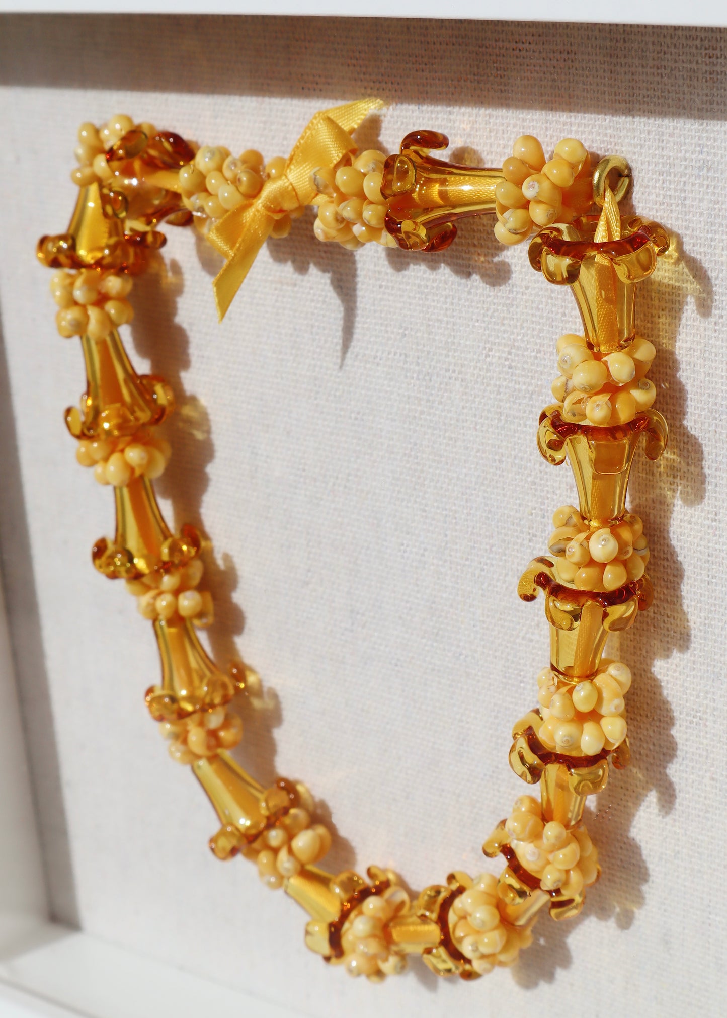 Puakenikeni Glass & Shell Lei in 9" x 9" Shadowbox