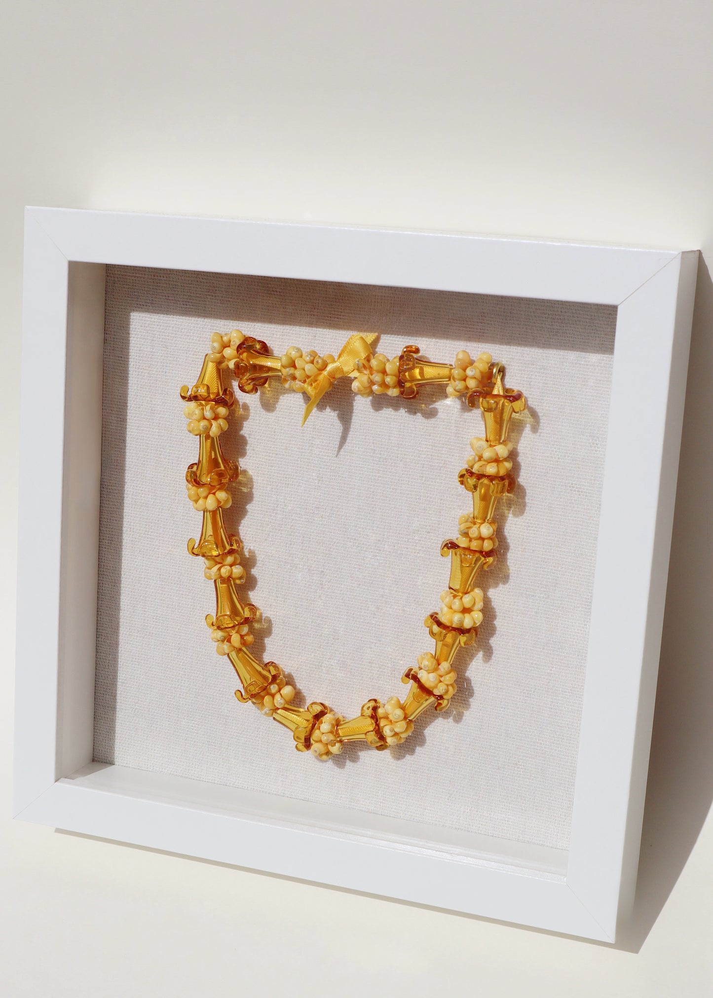 Puakenikeni Glass & Shell Lei in 9" x 9" Shadowbox