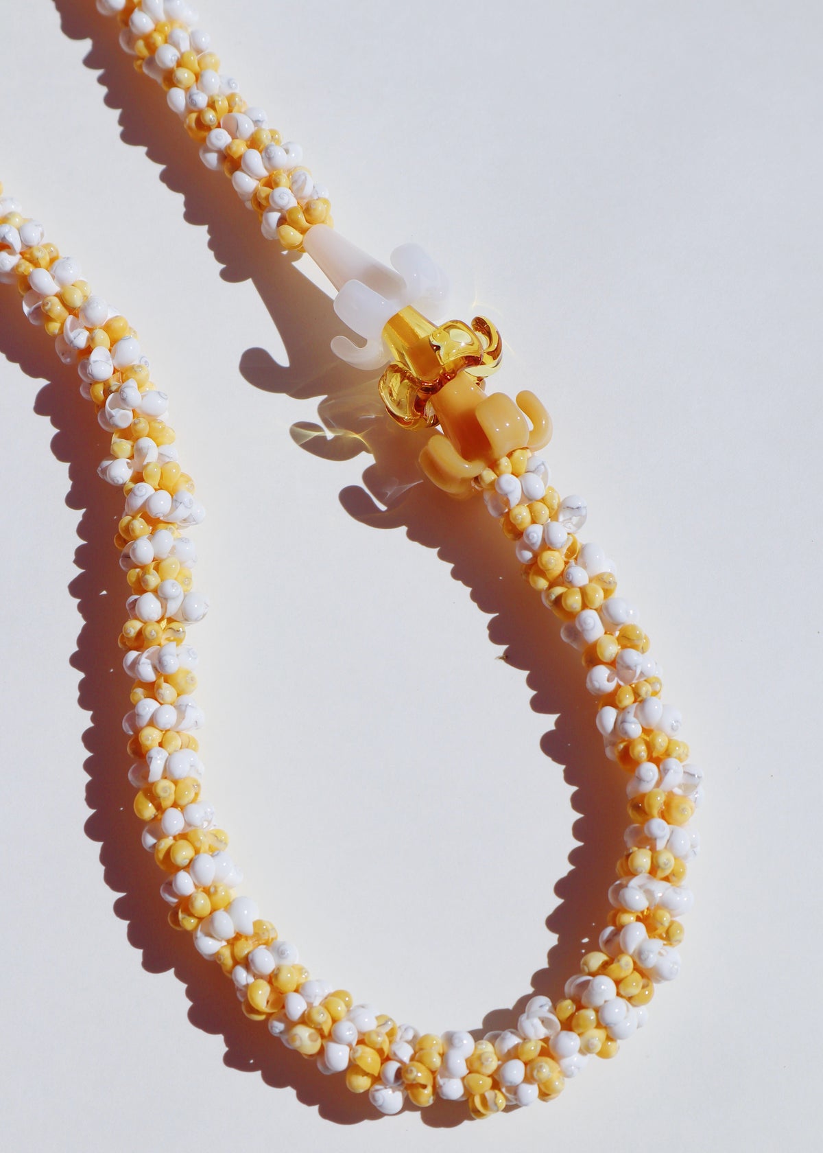 Mixed Color Puakenikeni Mongo Shell Lei with 3 Glass Pua